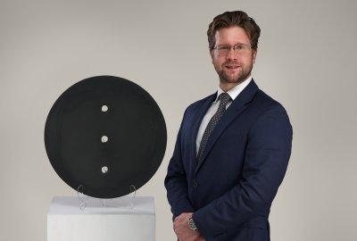 Malyk pictured with Lucio Fontana’s “Concetto Spaziale,” which will be offered in the May 1 Modern & Contemporary Art auction