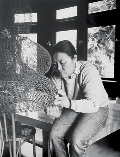 Ruth Asawa works on a crocheted-wire sculpture in her living room, ca.  1976.  Photo by Allen Nomura.