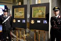 Carabinieri (Italian paramilitary police) officers flank the recovered artworks by Gauguin and Bonnard at a press conference in Rome on April 2, 2014.