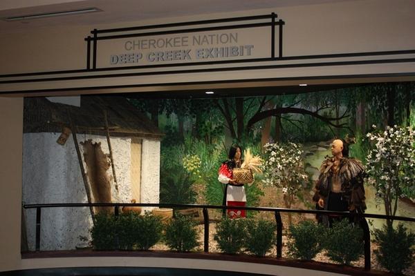 The Deep Creek exhibit at Cherokee Casino & Hotel West Siloam Springs, an art display featuring authentic Cherokee art recreating a scene from the late 1790s to the early 1800s of a Cherokee family of two outside a summer home.