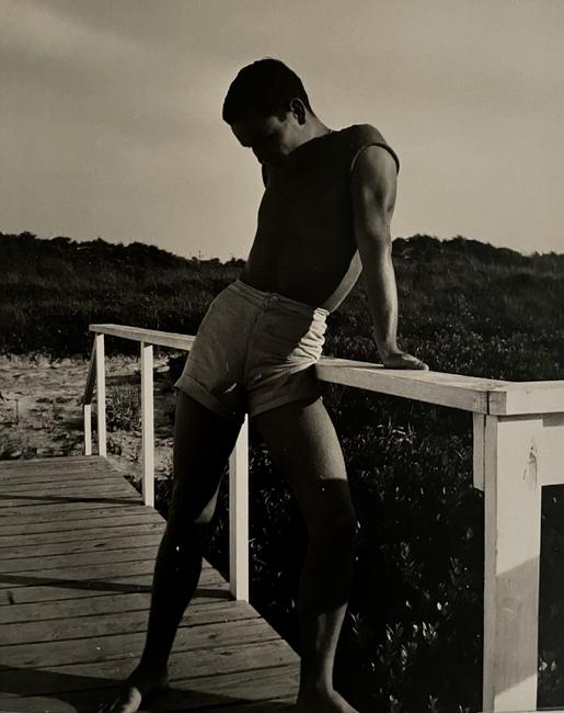 George Platt Lynes, American (1907-1955), [Chuck Howard on Boardwalk, Probably Fire Island], c.1950, Vintage gelatin silver print, 9 1/2 x 7 5/8 inches