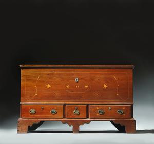 INLAID CHIPPENDALE BLANKET CHEST.  Pennsylvania, dated 1818, walnut and pine.  Dovetailed chest over three drawers on bracket feet and an interior till.  Decorated with tulip, star, and fylfot inlay.  Retains original brasses, hinges, and finish.  29.5"h.  49.5"w.  23"d.  Estimate $ 4,000-8,000 