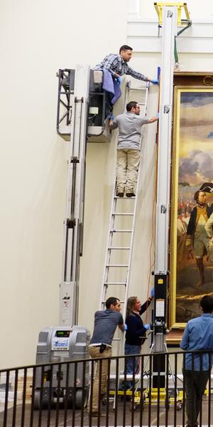 A copy of French artist Louis Charles-Auguste Couder’s Siege of Yorktown (1781) being installed at the Museum of the American Revolution.