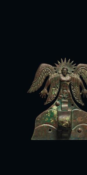 Appliqué depicting the Sun God Usil, Etruscan, 500 - 475 B.C.  Italy, made in Vulci.  Bronze.  H: 20 cm (7 7/8 in.) The J.  Paul Getty Museum, Villa Collection, Malibu, California