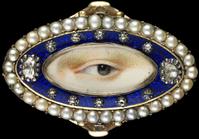 Rose gold oval ring surrounded by a blue enamel border containing ten small and two large diamonds enclosed in a border of natural split pearls, ca.  1790.  Brown left eye.  Purchased from Edith Weber, New York.  Dimensions: 3⁄4 × 1 1⁄4 × 7⁄8 in.