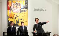 Former auctioneer Tobias Meyer, conducting the auction with Basquiat’s Orange Sports Figure behind him, which went on to sell for £4,073,250.