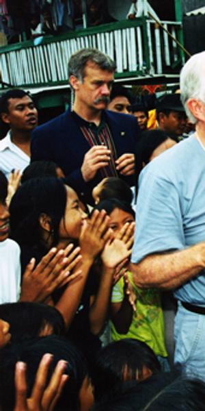 Former U.S.  President Jimmy Carter and former First Lady Rosalynn Carter shaking hands with children during the Indonesian elections June 5-9, 1999.