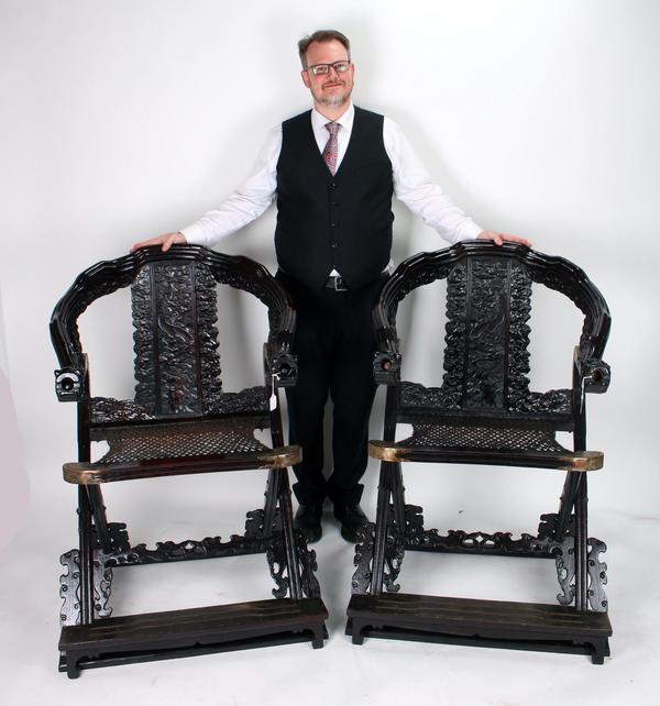 An expected top lot is this pair of elaborate zitan folding chairs with dragon arms, heavily carved legs, arm rests and back, all in a dragon and cloud motif (est.  $3,000-$5,000).