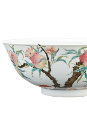 Lot 411 Chinese Famille Rose Enameled Porcelain Bowl, Qing Dynasty/ The delicately rounded sides painted on the exterior with blossoming and flowering peach branches, the leafy stems extending over the rim to the interior where three iron red bats fly amid the pink blossoms, base with four-character hallmark in iron red.  Diameter 6 5/8 inches.  Provenance: Douglas J.  K Wright Ltd., London/ From the Estate of Peter K.  Warren.  Estimate: $15,000-25,000 