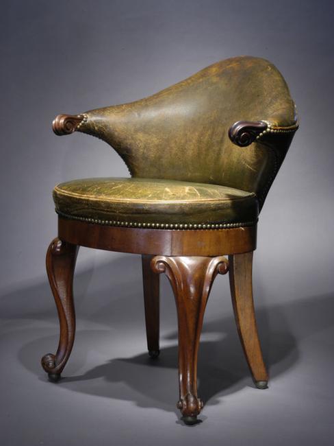 Rare Dutch leather and mahogany musician's chair with low cartouche-shaped back and scroll carved arms on a balloon seat with show apron and bold front cabriole legs ending in scroll feet.  c.1840.  