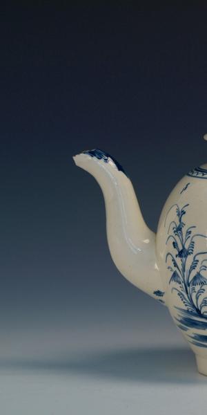 An illustrated Staffordshire creamware teapot with “Sally Sikes Drinking Tea, 1780” inscription