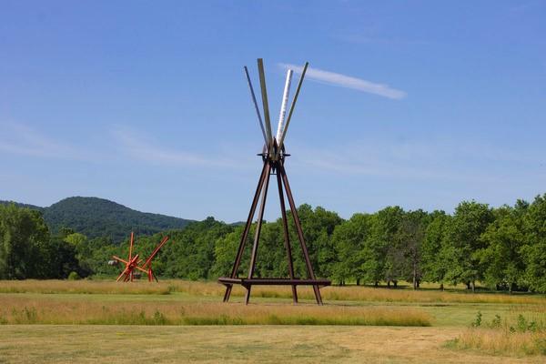 View of the south fields, all works by Mark di Suvero.  Left to right: Figolu, 2005–11.  Courtesy the artist and Spacetime C.C.  E=MC2 , 1996-97.  Courtesy the artist and Spacetime C.C.  ©Mark di Suvero, courtesy the artist and Spacetime C.C., New York.  Photo courtesy Storm King Art Center.  