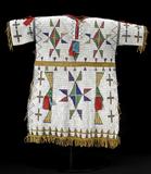 A Sioux fully-beaded buckskin dress (est.  $40/60,000) will be offered by Bonhams & Butterfields in San Francisco on 7 June 2010 during the summer Native American Art auction.  Imaginatively decorated with a profusion of geometric configurations - mostly triangle and diamond forms - the dress is 29-inches in length...  Photo Credit: Courtesy Bonhams & Butterfields 