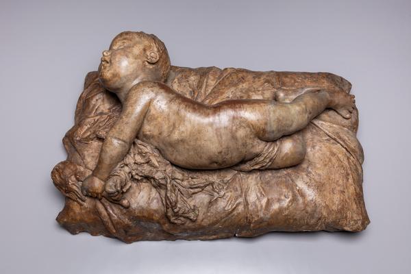 Agustín Querol y Subirats (Spanish, 1864–1909), A Baby Rolling Over, 1884–87.  Terracotta, 15 ¾ x 25 ¼ x 8 ¾ in.  (40 x 64 x 22 cm).  Meadows Museum, SMU, Dallas.  Given by Michael P.  Mezzatestain honor of William B.  Jordan, MM.2020.02.  Photo by Kevin Todora.