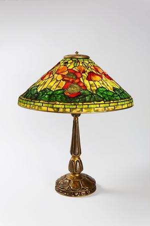 Macklowe Gallery- A Tiffany Studios New York wire mesh "Poppy" leaded glass and gilt bronze table lamp.  