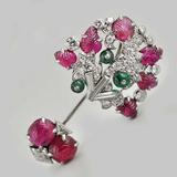 Beautiful jabot pin designed as a stylised foliate motif with carved rubies, diamonds and emerald beads. Cartier New York c1925 www.hancocks-london.com/