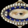 Rose gold oval ring surrounded by a blue enamel border containing ten small and two large diamonds enclosed in a border of natural split pearls, ca.  1790.  Brown left eye.  Purchased from Edith Weber, New York.  Dimensions: 3⁄4 × 1 1⁄4 × 7⁄8 in.