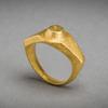 A massive Imperial Roman solid gold ring of angular wide shouldered style, a raised circular boss on the bezel.  Intact, 3d - 4th Centuries AD, eastern Mediterranean.