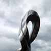 Santiago Medina’s “Infinity” is made with highly polished Italian stainless steel and displays in its organic sculptoric form, the infinite symbol.  The sculpture measures 24 inches in height by 12 x 10 inches.  Infinity is pictured in front of the Colombian landscape where it was cast in stainless steel at Medina’s studio in Medellin, Colombia and will be shipped to its permanent home at the Tisch Library, Tufts University, Boston, MA.