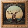 Circa 1901 original Elks Whiskey painted raised metal sign, pulled from the Tombstone Museum with a painting of an elk in a mountain forest setting, housed in an 18 inch by 18 frame ($1,560).