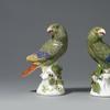 An Important Pair of Early Meissen models of South American Parrots, modelled by Johann Joachim Käendler each perched upon a white tree stump and looking to one side, beautifully naturalistically coloured, each representing a Green Amazon Parrot painted in green with puce detailing to its plumage, and with red, blue and yellow wing tips and tail, the tree stumps issuing leafy berried branches.  Circa 1738-42 1st height: 7 ¾ in (19 ½ cms)2nd height: 7 ½ ins (19 cms) 