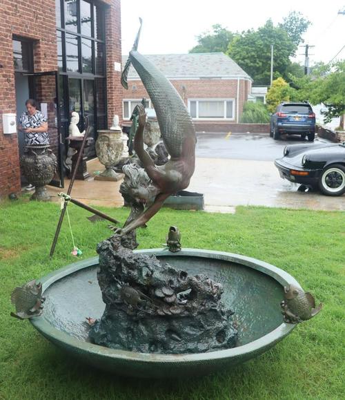 Garden antiques sell well and a highlight here is this large bronze dolphin form fountain with frogs, signed Jerry Joslin, 68 inches tall ($3/5,000).