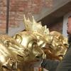 Ai Weiwei in his Beijing studio examining early versions of heads from Circle of Animals/Zodiac Heads: Gold, 2010