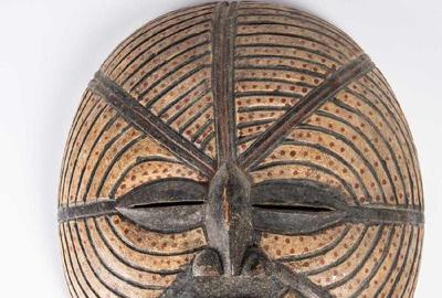 Luba tribe (Democratic Republic of Congo) carved and painted wood moon mask, 20th century, with almond shaped eyes, a small nose and prominent mouth, 17 ½ inches tall (est.  $80-$120).  