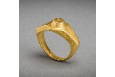 A massive Imperial Roman solid gold ring of angular wide shouldered style, a raised circular boss on the bezel.  Intact, 3d - 4th Centuries AD, eastern Mediterranean.