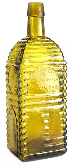 The auction’s top lot was this American Life Bitters bottle (P.E.  Iler, Mfg., Tiffin, Ohio), circa 1865-1875, 9 ¼ inches tall, in a light to medium yellow color with an olive tone cabin ($42,000).