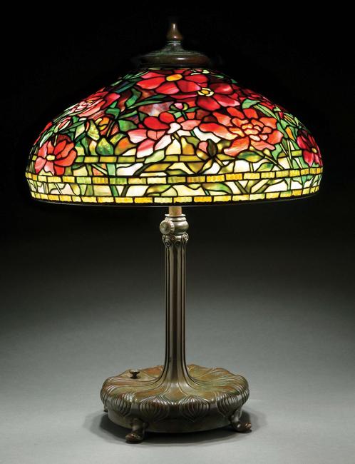 Circa-1910 Tiffany Studios ‘Peony’ leaded-glass table lamp, both 22in shade and telescopic, six-socket ‘Chased Pod’ base are signed.  Excellent condition.  Estimate $100,000-$150,000