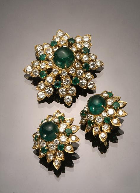 A 18-karat yellow-gold, emerald and diamond floral-form three piece ensemble by Van Cleef & Arpels realized $41,125.