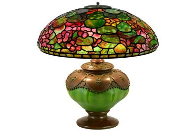 A parade of fine examples of Tiffany Studios lamps will be offered, featuring this “Nasturtium” table lamp ($80/120,000), circa 1905, having a 20-inch diameter shade that was signed twice, one being an early tag impressed “Tiffany Studios New York,” The oil canister is impressed “Tiffany Studios, New York, 28644” with the Tiffany Glass & Decorating Company monogram.