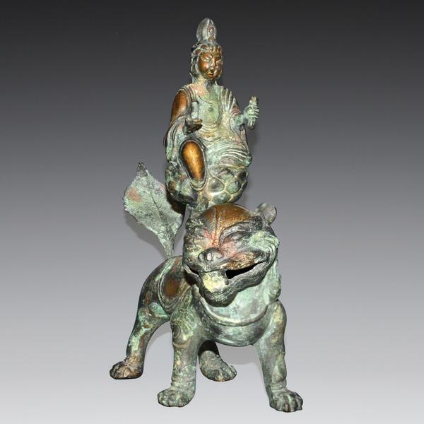 Bronze Bodhisattva Manjushri riding on the back of a Buddhist lion.  10” tall.  Weight, 4 pounds.  Lot 153.  Gianguan Auctions, June 10, 2017.