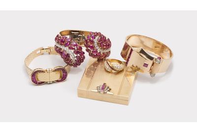 A selection of jewelry from The October Auction including a Van Cleef & Arpels covered wristwatch, a Boucheron carved ruby cuff bracelet, and a Raymond Yard compact.