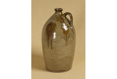 Attributed to John Davis Leopard; possibly Ussery shop, (1800/03SC–1883 TX), Bacon Level, Randolph County, Single Handle Jug, 1840s, Elaborately tooled rim, concentric lines decoration, alkaline glaze with reddish-brown iron oxide overglaze, 16 x 9 x 9 inches, Collection of Gary and Martha Price