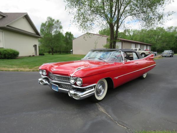 Completely restored, iconic 1959 Cadillac convertible, series 62 model, red in color with a white convertible top, a 325 hp 390 c.i.  V8 engine and 57,533 miles on the odometer.