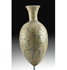 Ancient Egyptian late-18th-Dynasty Amarna faience lotus bottle with glyphs, circa 1353-1336 BCE, 5.626 inches high (7.6 inches with included stand).  Estimate: $15,000-$20,000.  