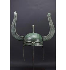 Greek bronze winged helmet, Late Classical of Chalcidian type, circa 400 BC, heavy sheet metal with cheek-pieces, plume-holder, and distinctive wings.  Ex Axel Guttmann collection.  Estimate £40,000-£60,000 ($49,000-$73,600)