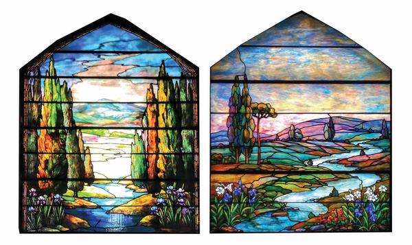 Lot of two leaded-glass windows attributed to Tiffany Studios.  Window at left shows poplar trees bordering a stream, while window at right, measuring 41 x 80in., features rolling hills and meadows, and is similar to an example in Alastair Duncan’s book ‘Tiffany Windows.’ Lot estimate $100,000-$250,000