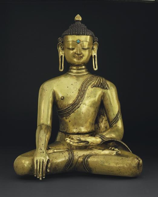 A large and important gilt bronze figure of Buddha Nepal, 14th century, 23 in.  high 