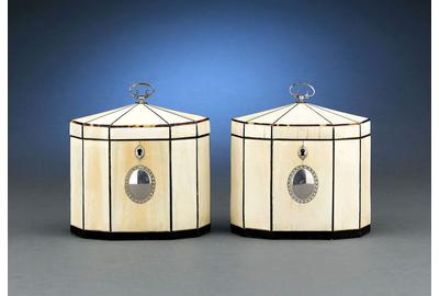 This extraordinary pair of George III period tea caddies are enveloped in ivory, with tortoiseshell and sterling silver trim and mounts.  Circa 1790.