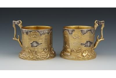 A Pair of Russian Silver and Gold Wash Trompe L'Oeil Tea Glass Holders, Marks of Ivan Khlebnikov with Imperial Warrant, Moscow, ca.  1900