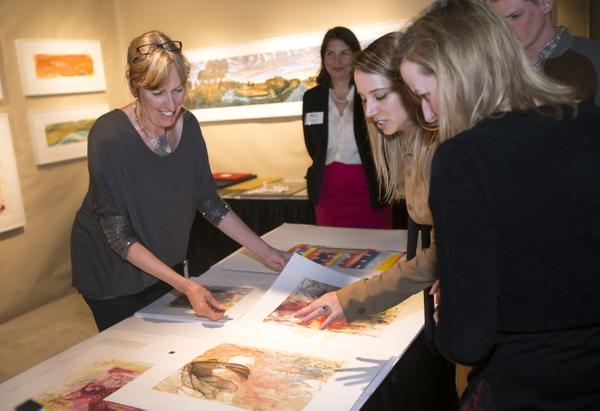 Sue Oehme of Oehme Graphics (CO) shows off prints at the AD20/21 Show & Sale during Boston Design Week 2016.