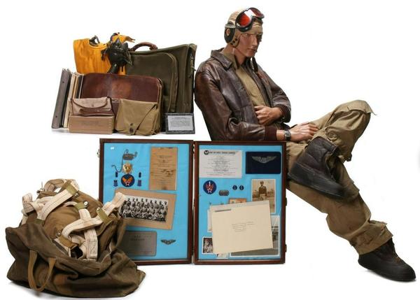 Important 75-piece archive of personal and service items belonging to Tuskegee Airman William S.  Powell Jr.  Uniform includes A-2 leather jacket with squadron patch and name, flight suit and other apparel with all insignia, parachute, kit bag, flight log, many documents including Tuskegee diploma with signatures of classmates and instructors.  Estimate $40,000-$60,000