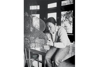 Ruth Asawa works on a crocheted-wire sculpture in her living room, ca.  1976.  Photo by Allen Nomura.