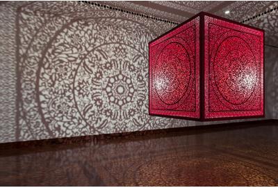 Anila Quayyum Agha (b.  1965), All the Flowers Are for Me (Red), laser-cut lacquered steel and lightbulb, 60x60x60 in, Alice Bimel Endowment for Asian Art, 2017.7