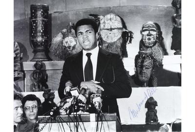 An autographed photo of Ali announcing The Rumble in the Jungle match between he and George Foreman in 1974.