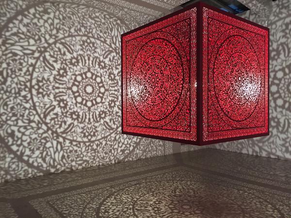 Anila Quayyum Agha (b.  1965), All the Flowers Are for Me (Red), laser-cut lacquered steel and lightbulb, 60x60x60 in, Alice Bimel Endowment for Asian Art, 2017.7