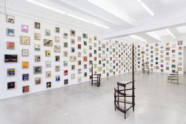 Valeska Soares, "Any Moment Now…", 2014.  365 vintage dust jackets mounted on linen panels and 4 vintage library ladders.  Installation view Eleven Rivington Gallery, 2014.  Courtesy Fortes D’Aloia & Gabriel, São Paulo.  Photo Credit: Charles Benton.  Image courtesy of the Artist.